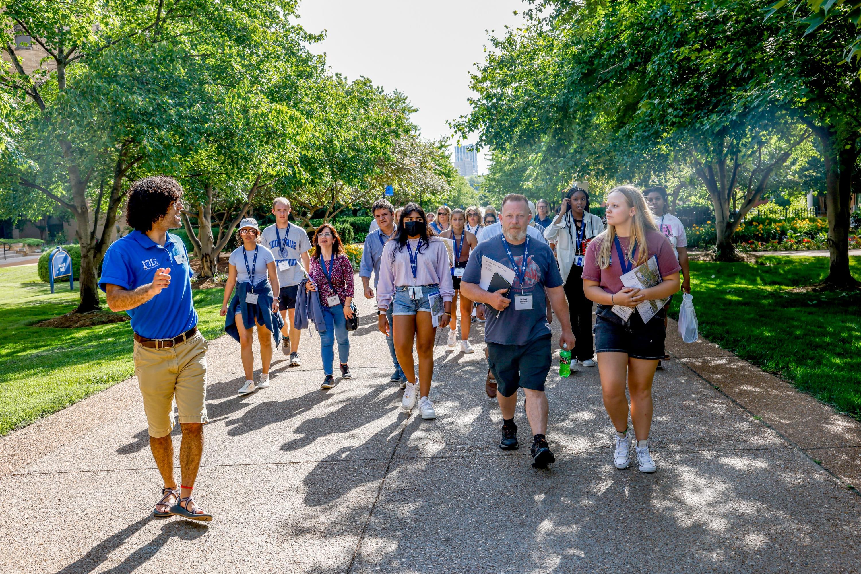 Students following their group leader on a tour of campus
